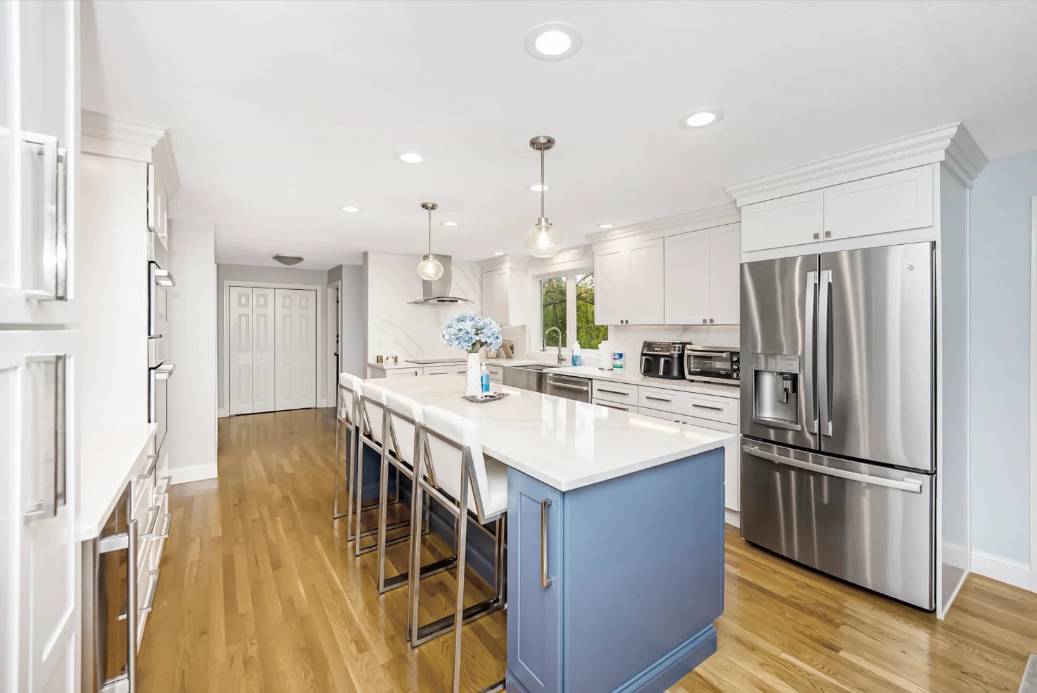 light blue kitchen island with stainless steal appliances