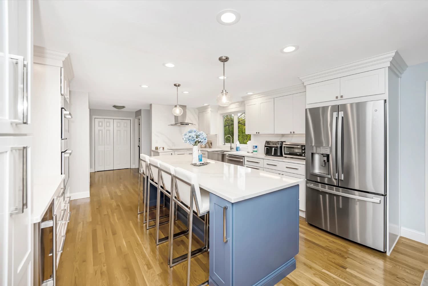 light blue kitchen island with stainless steal appliances